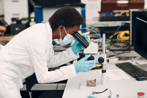 Scientist African American woman working in laboratory with electronic instruments, researching How is IVF Done?